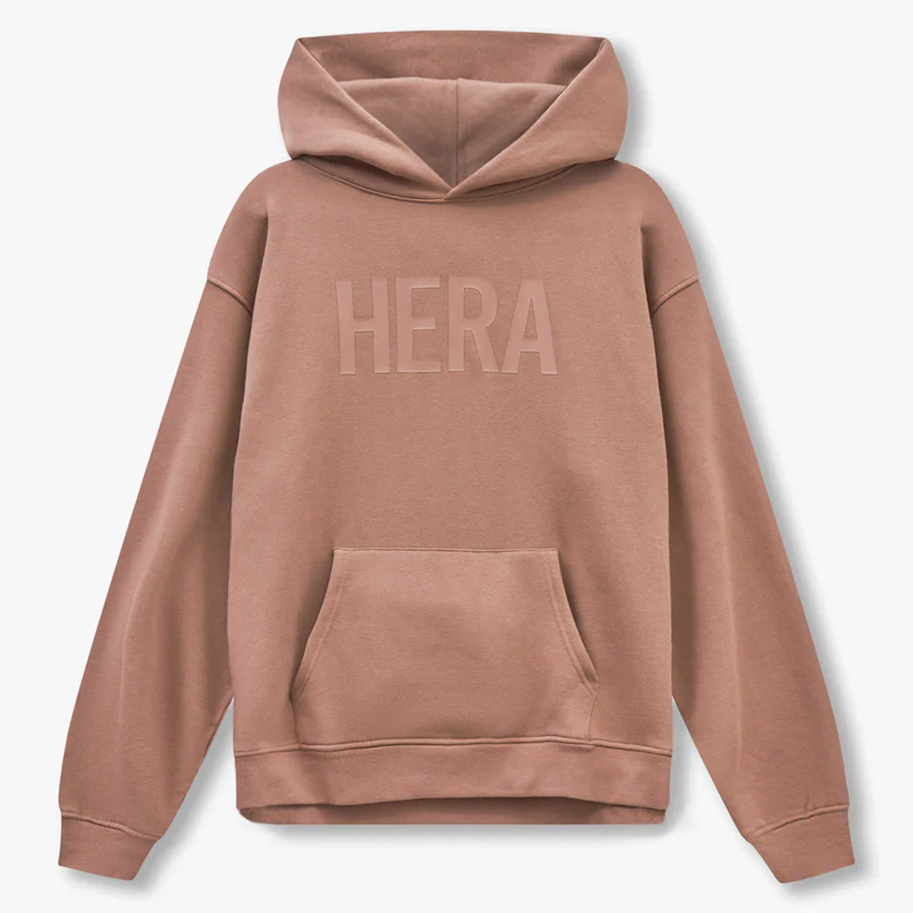 Brown hoodie with 'HERA' branding on the back against a light gray background