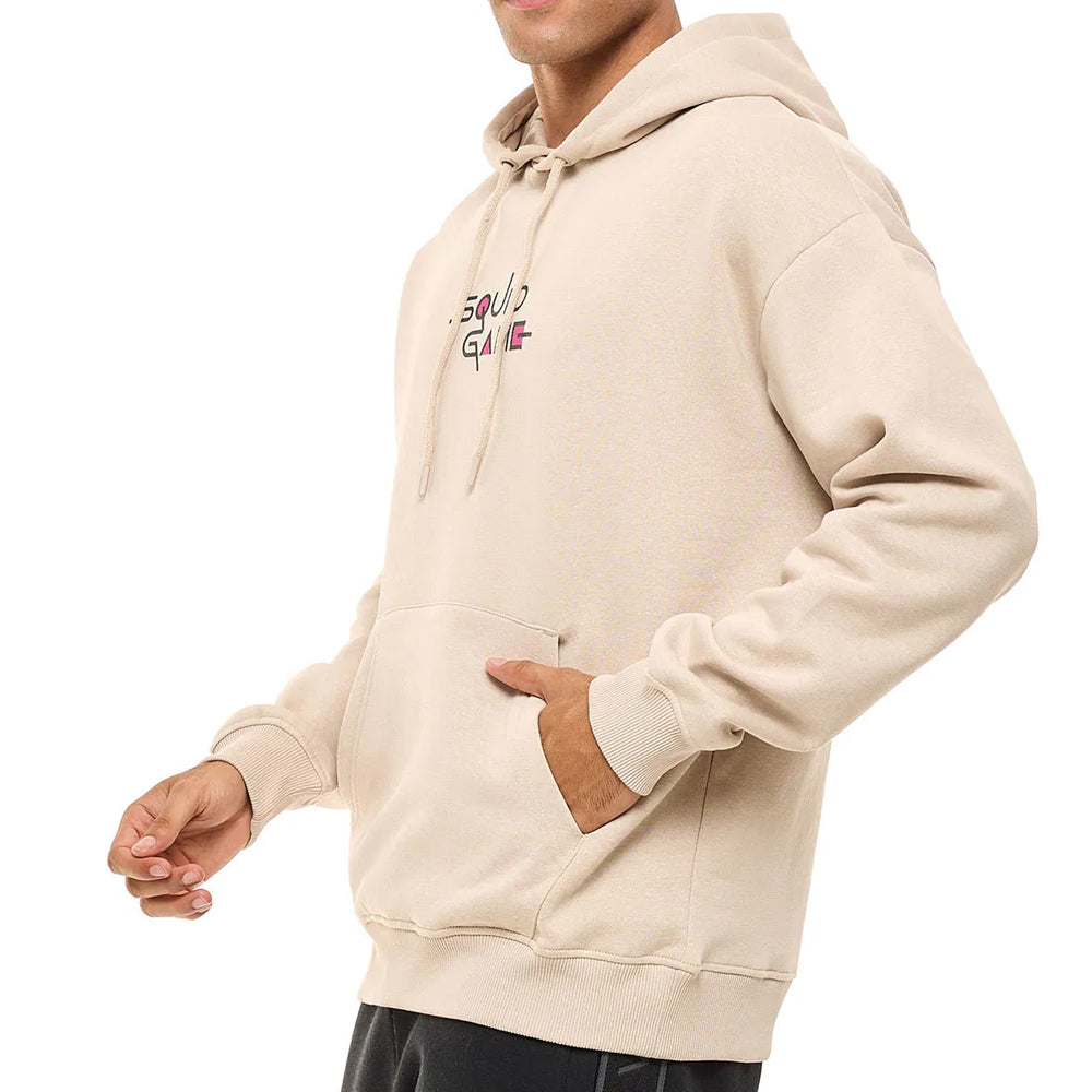 Beige hoodie with brand logo worn by a person on a white background