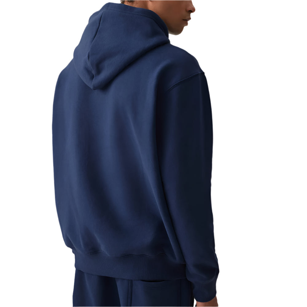 Person wearing a navy blue hoodie on a plain background