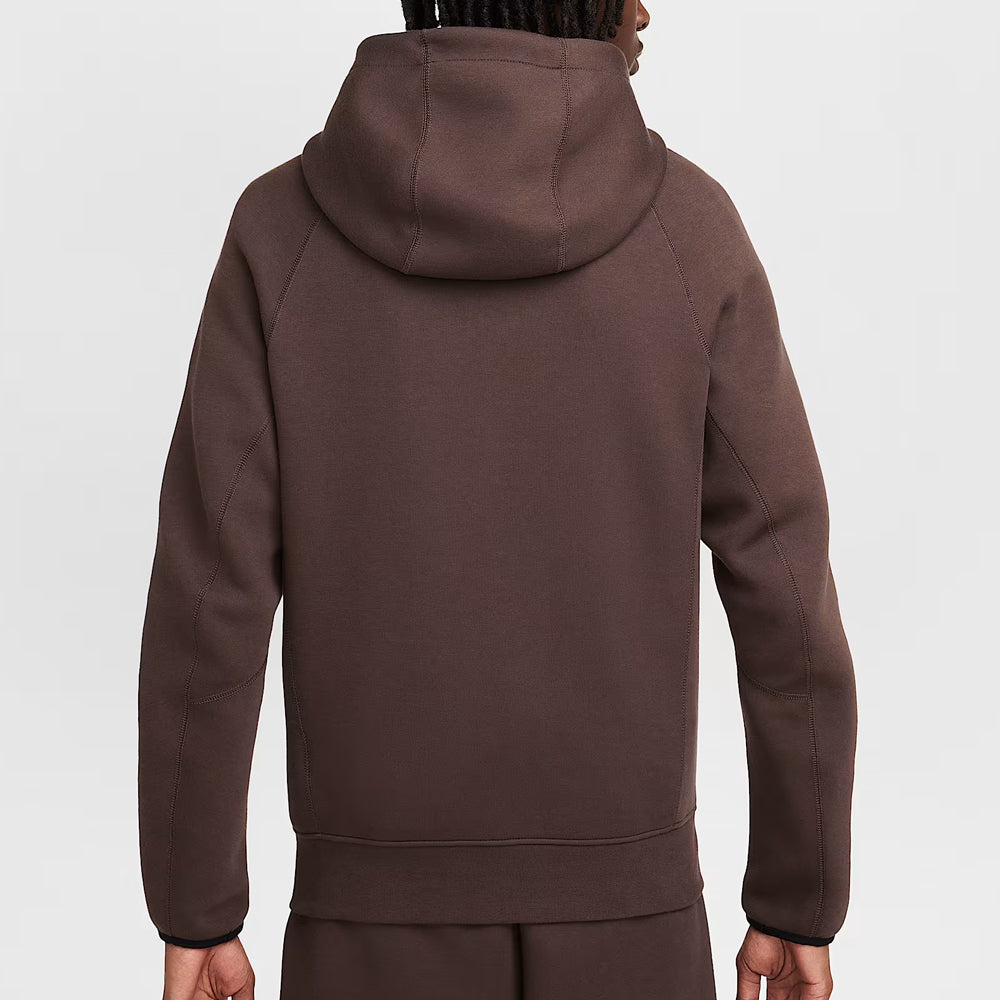 Brown hoodie worn by a person on a white background
