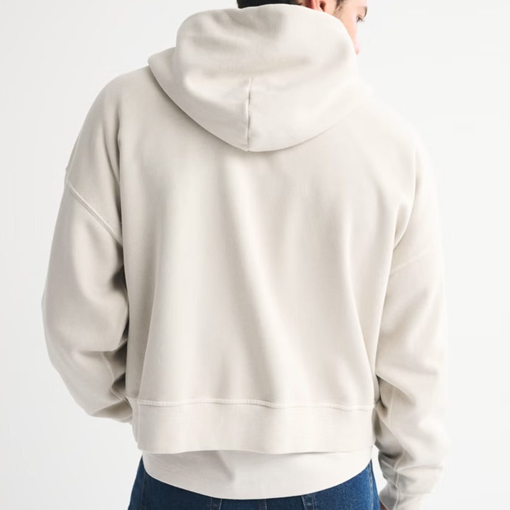 Beige hoodie worn by a person on a white background