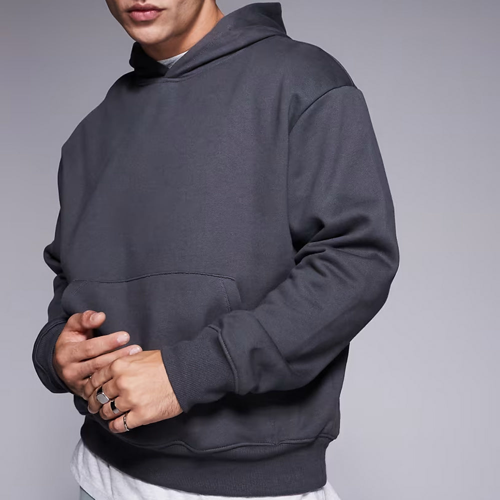 Person wearing a dark gray hoodie against a plain background