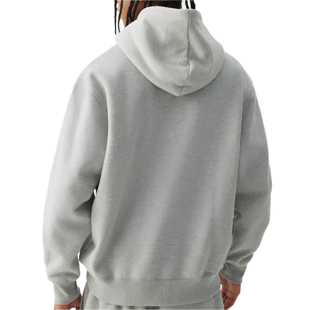 Person wearing a gray hoodie on a plain background