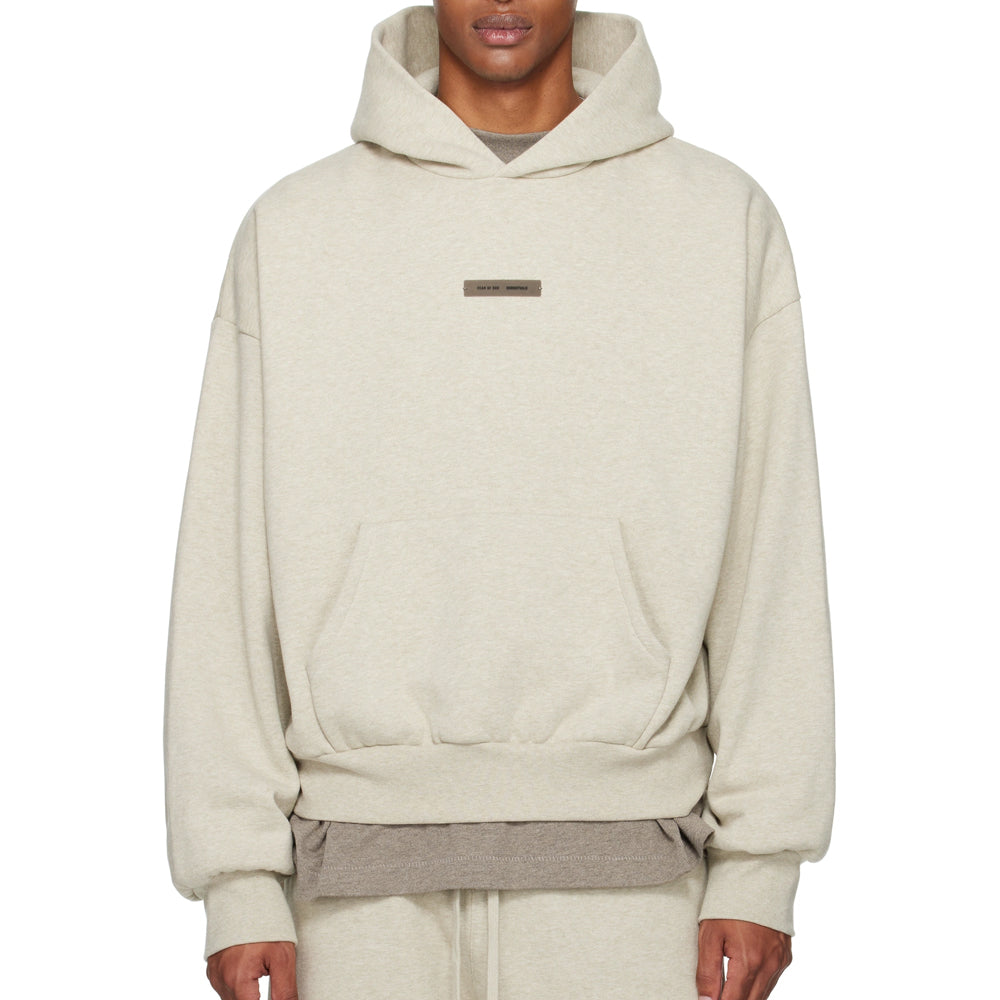 Beige hoodie worn by a person on a white background
