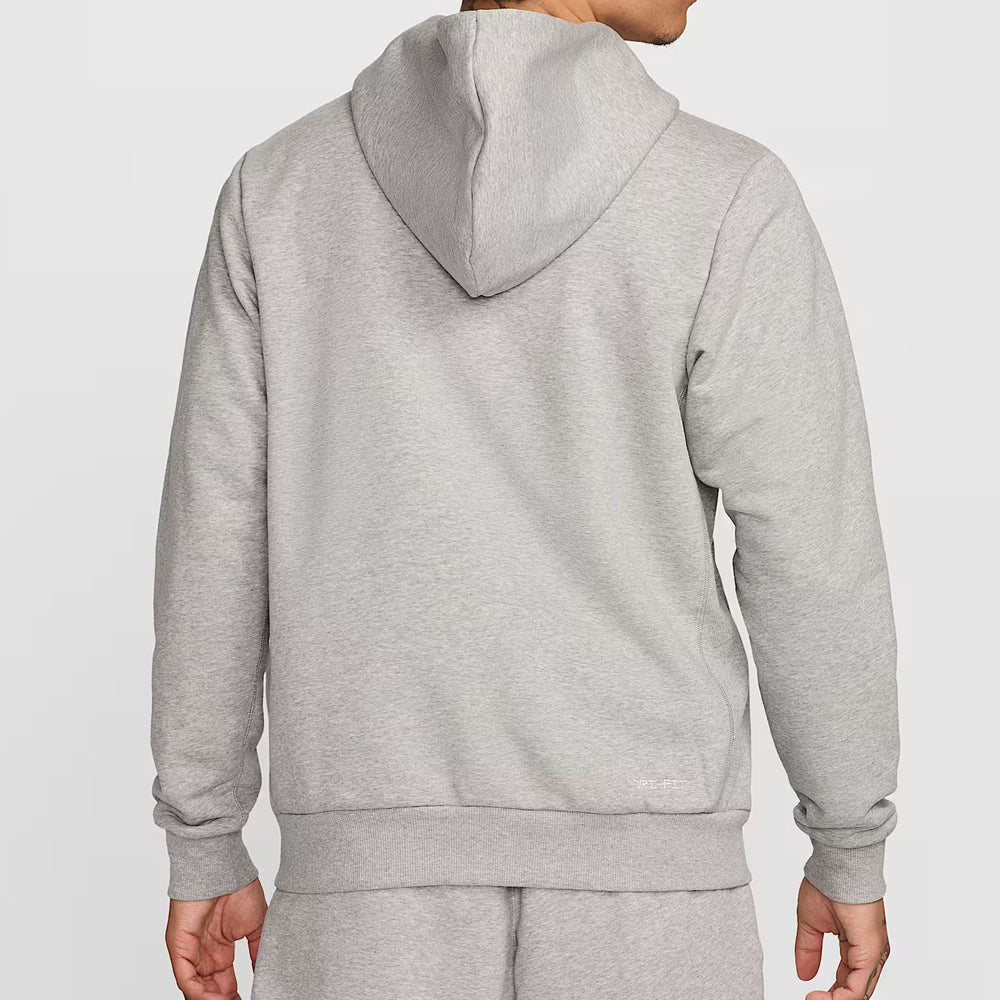 Person wearing a gray hoodie and pants on a light gray background