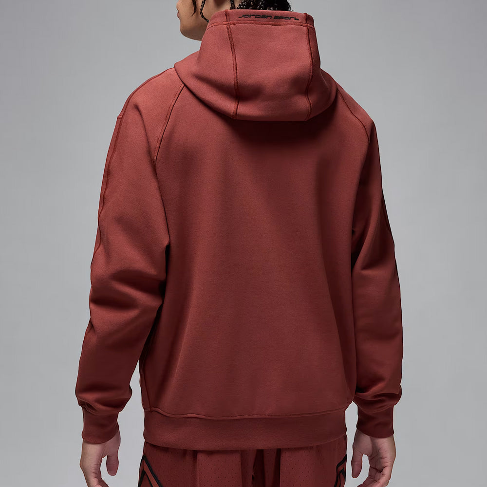 Maroon hoodie worn by a person on a gray background