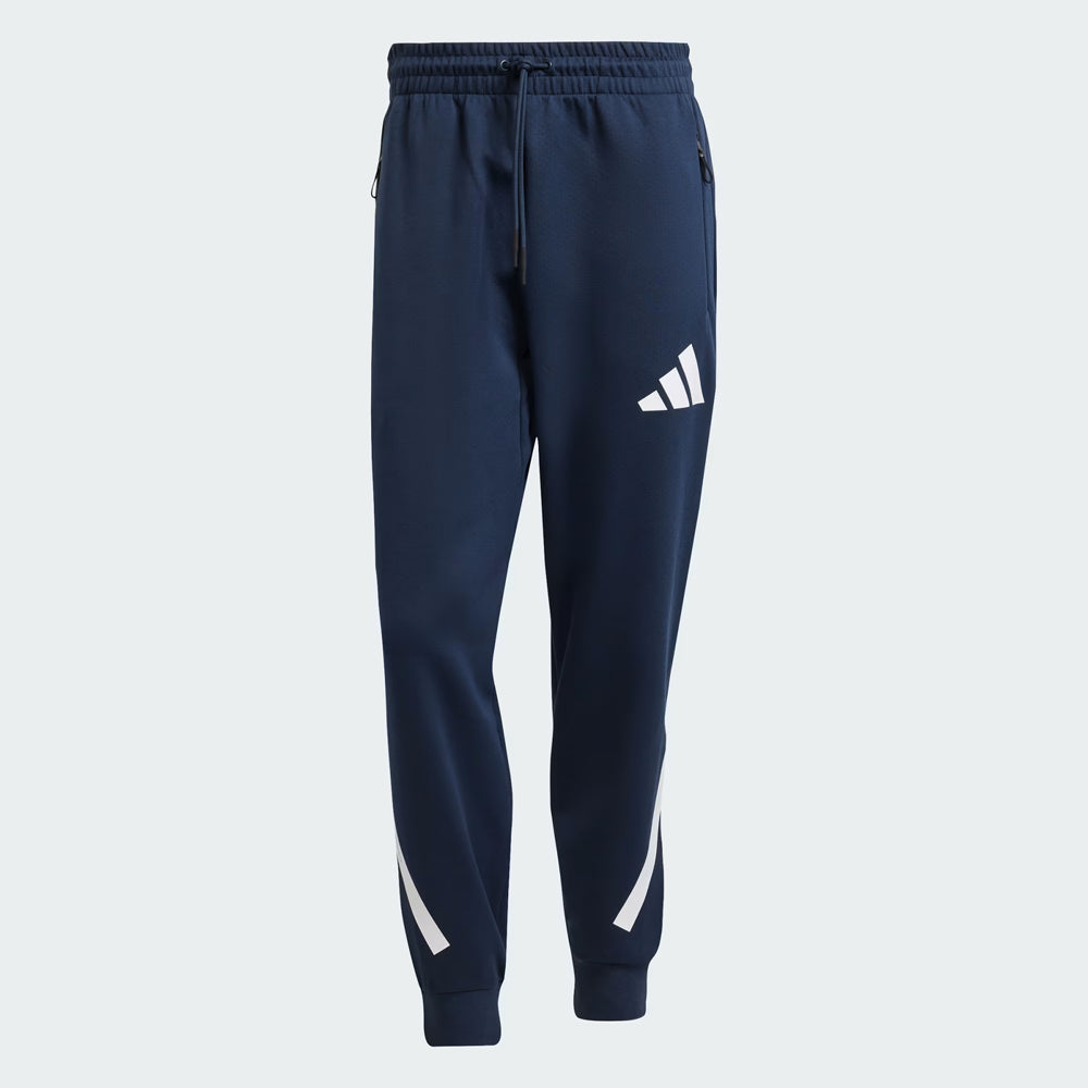 Navy blue Adidas tracksuit pants on a light gray background
