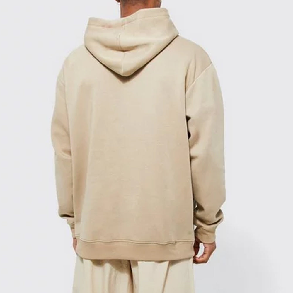 Beige hoodie worn by a person on a white background