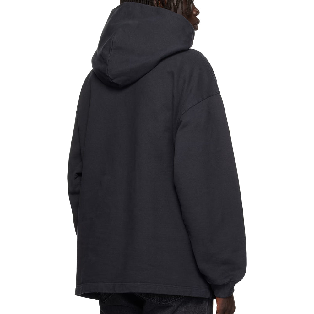 Person wearing a black hoodie from behind on a white background