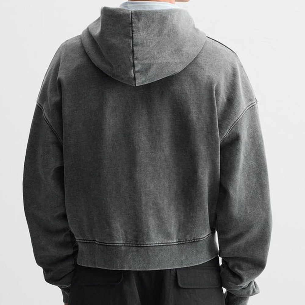 Person wearing a dark gray hoodie from behind on a light gray background