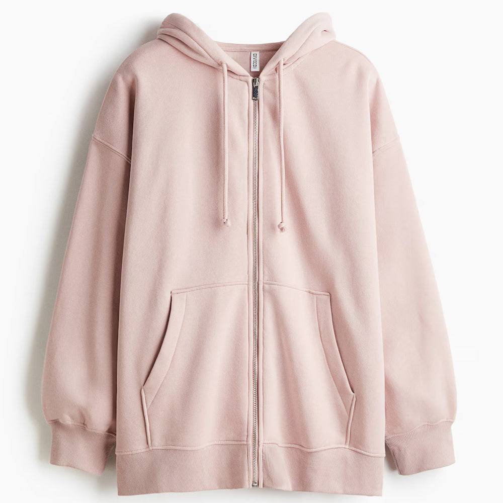 Pink hoodie with a zipper on a light gray background