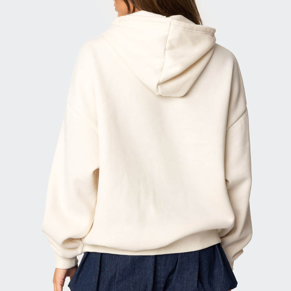 Person wearing a beige hoodie from behind on a light gray background
