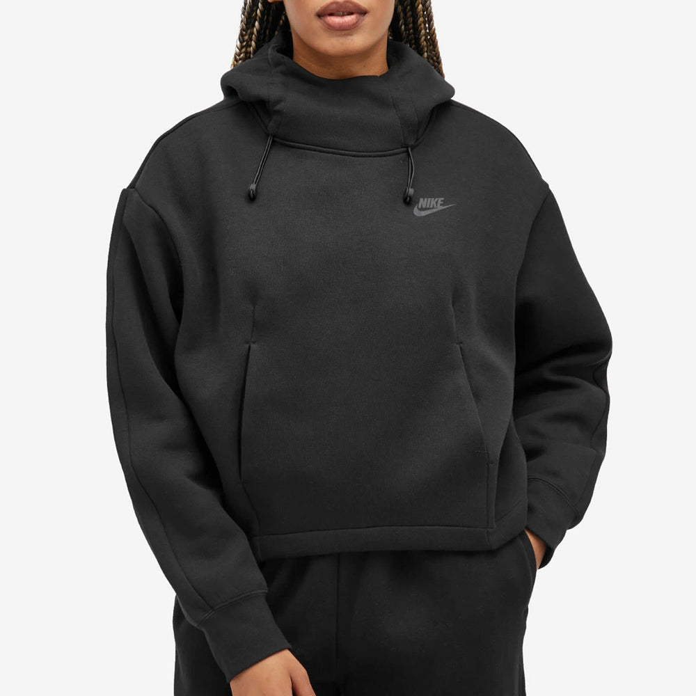 Person wearing a black Nike hoodie on a light gray background