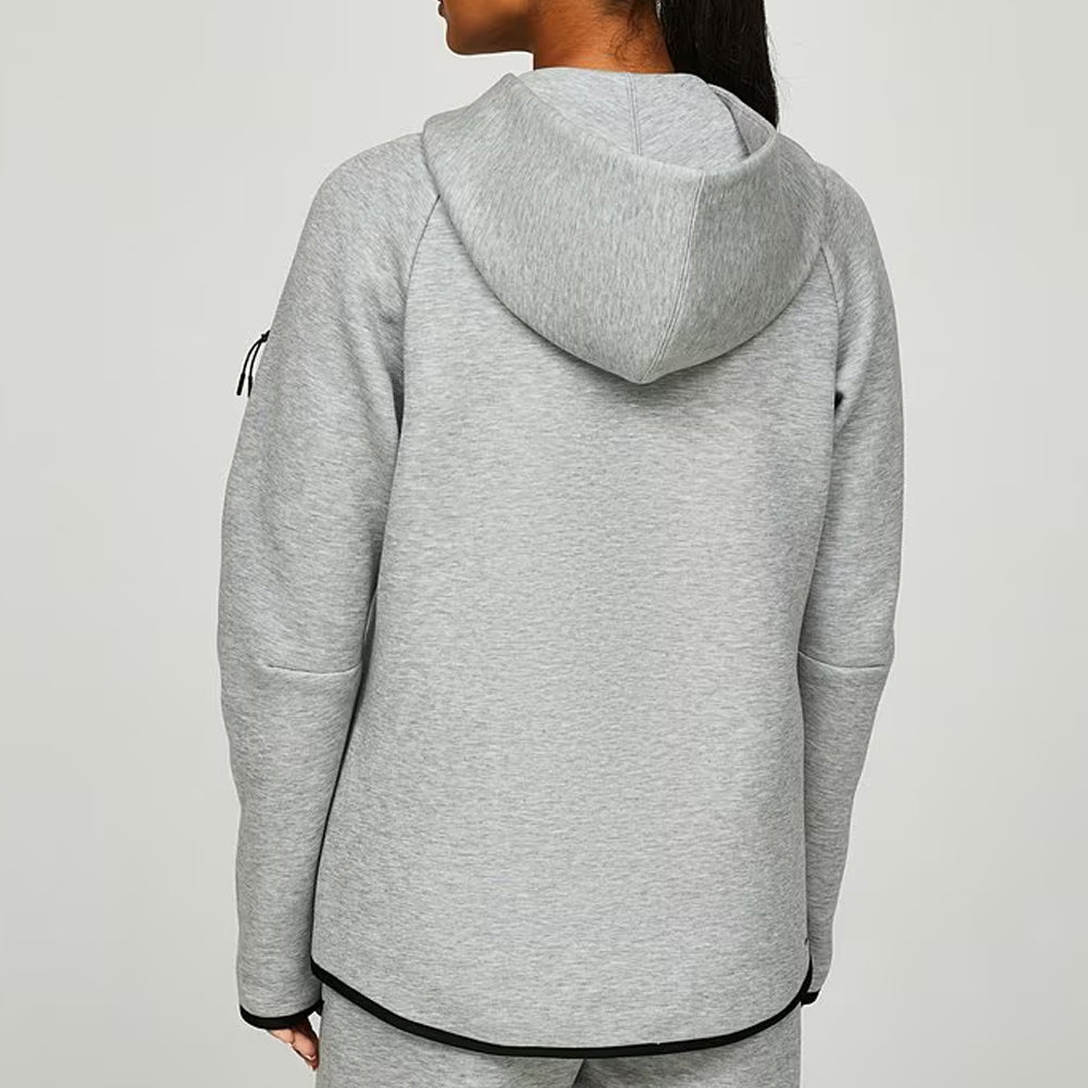Person wearing a gray hoodie on a light gray background