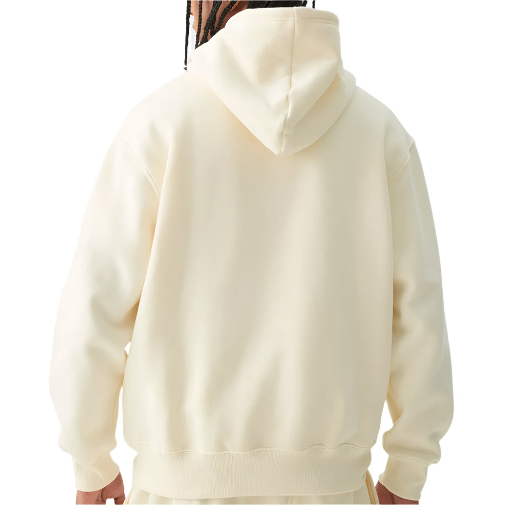 Back view of a person wearing a cream-colored hoodie on a light gray background