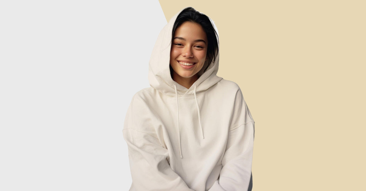 Person wearing a white hoodie on a beige background