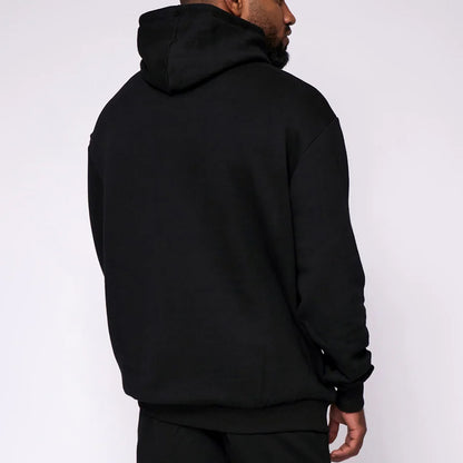 Person wearing a black hoodie from behind on a white background
