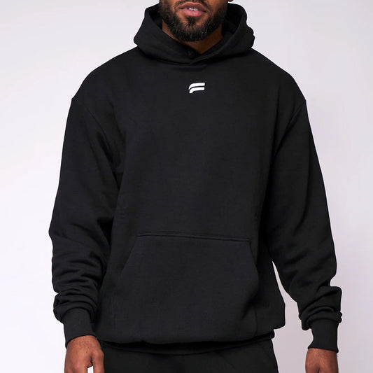 Person wearing a black hoodie with a logo on a white background