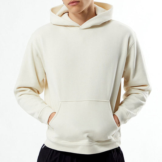 Person wearing a beige hoodie on a white background