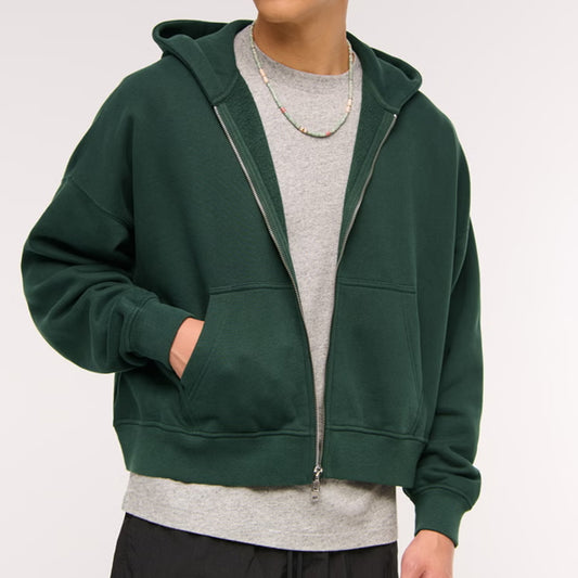 Green hoodie worn by a person on a white background