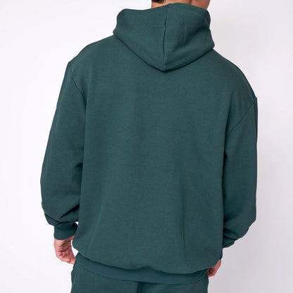 Green hoodie worn by a person on a white background