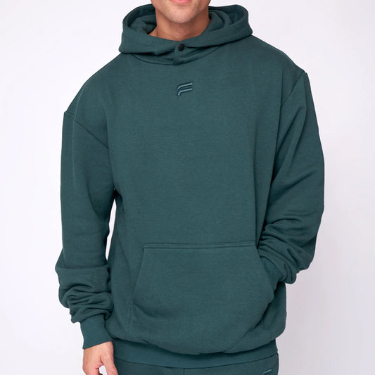 Person wearing a green hoodie with a logo on a white background