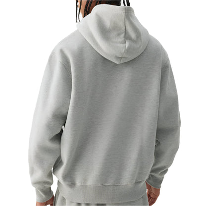 Person wearing a gray hoodie on a plain background