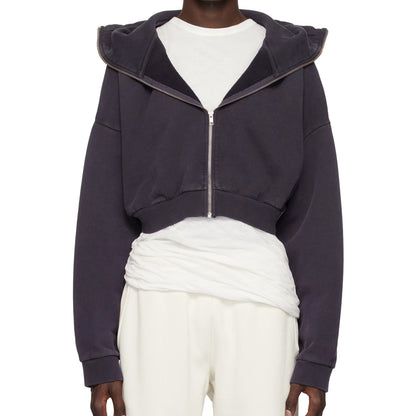 Navy blue zip-up hoodie worn over a white outfit on a white background