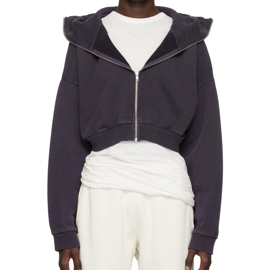 Navy blue zip-up hoodie worn over a white outfit on a white background