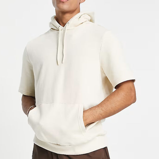 Person wearing a white hoodie on a plain background