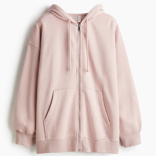 Pink hoodie with a zipper on a light gray background