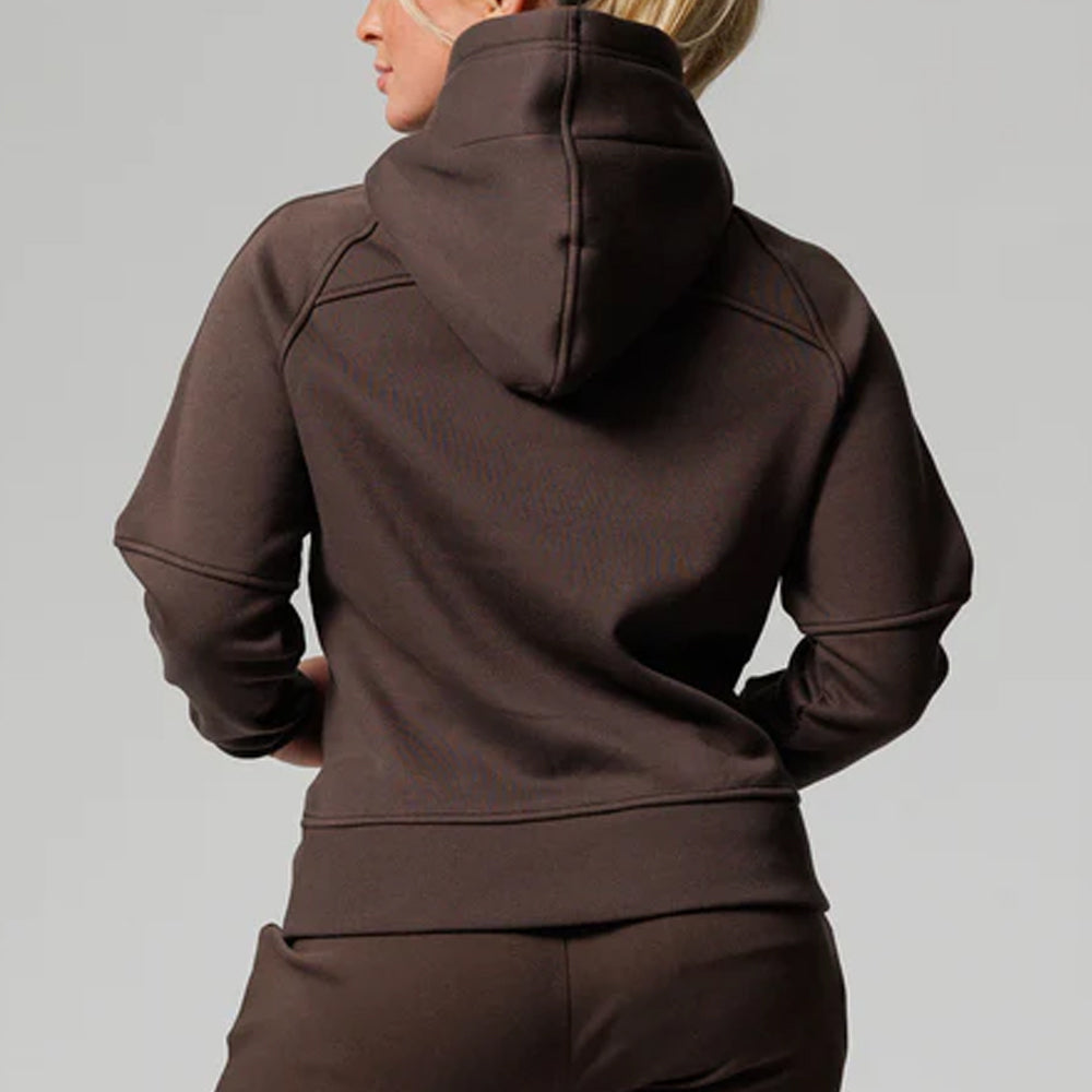 Person wearing a brown hoodie on a gray background